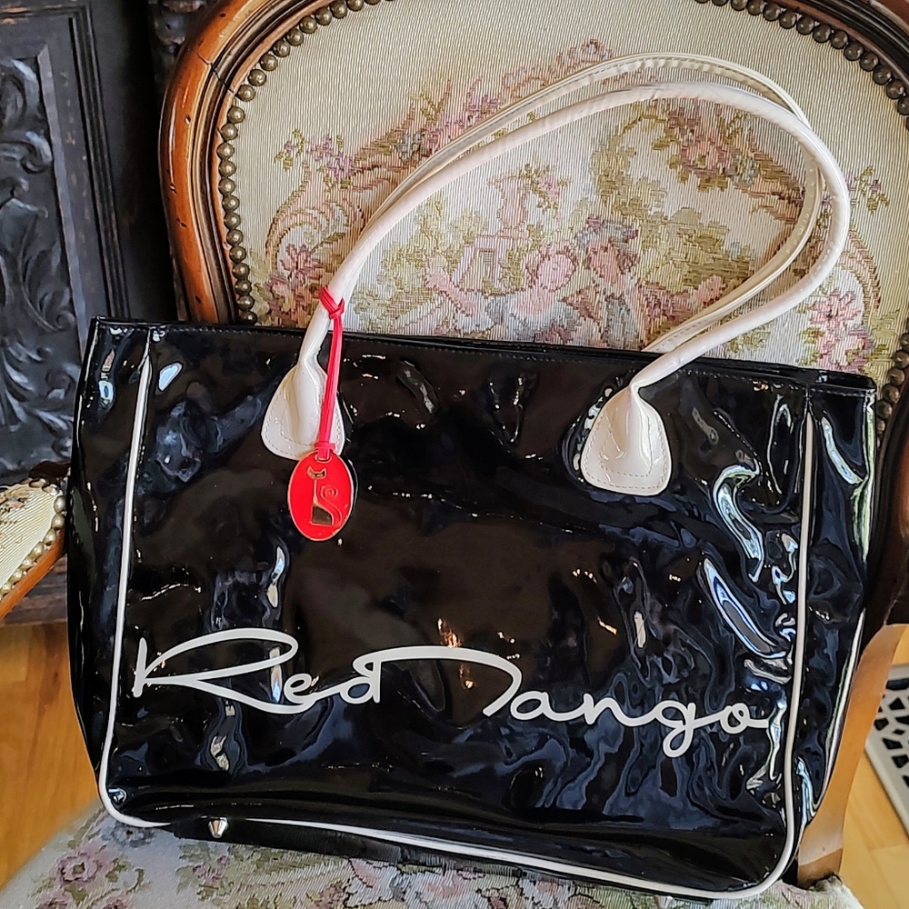Red Tango bag, black and red with kitty medallion. 14.5" by 10" preowned